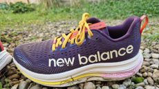 New Balance FuelCell SuperComp Trail on a gravel and grass path outside our tester's home