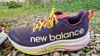 New Balance FuelCell SuperComp Trail on a gravel and grass path outside our tester's home