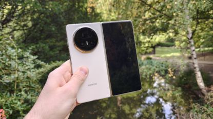 The Honor Magic V5 with a pond in the background