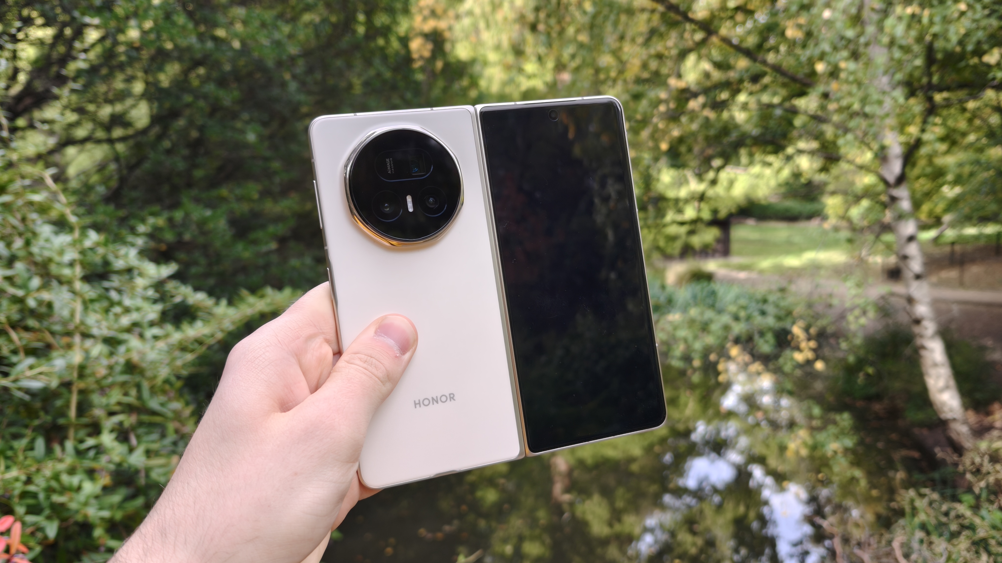 The Honor Magic V5 with a pond in the background
