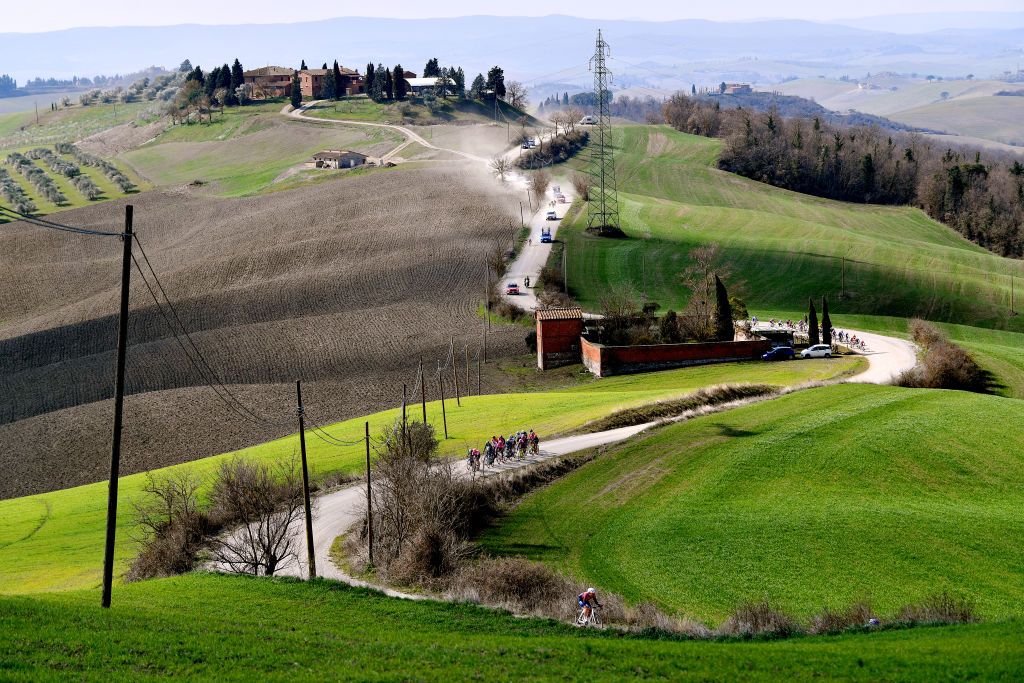 SIENA ITALY MARCH 05 A general view of the peloton passing through gravel roads landscape during the Eroica 8th Strade Bianche 2022 Womens Elite a 136km one day race from Siena to Siena Piazza del Campo 321m StradeBianche on March 05 2022 in Siena Italy Photo by Luc ClaessenGetty Images