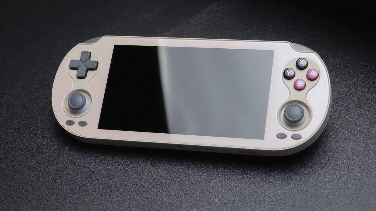 Beige Anbernic RG Vita on black surface.