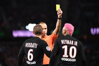 French referee Jerome Brisard (C) gives a yellow card to Paris Saint-Germain's Brazilian forward Neymar (R) during the French L1 football match between Paris Saint-Germain (PSG) and Montpellier Herault SC at the Parc des Princes stadium in Paris, on February 1, 2020.