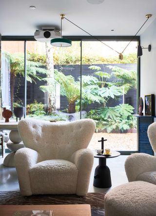 Open plan living room with outlook onto small patio garden