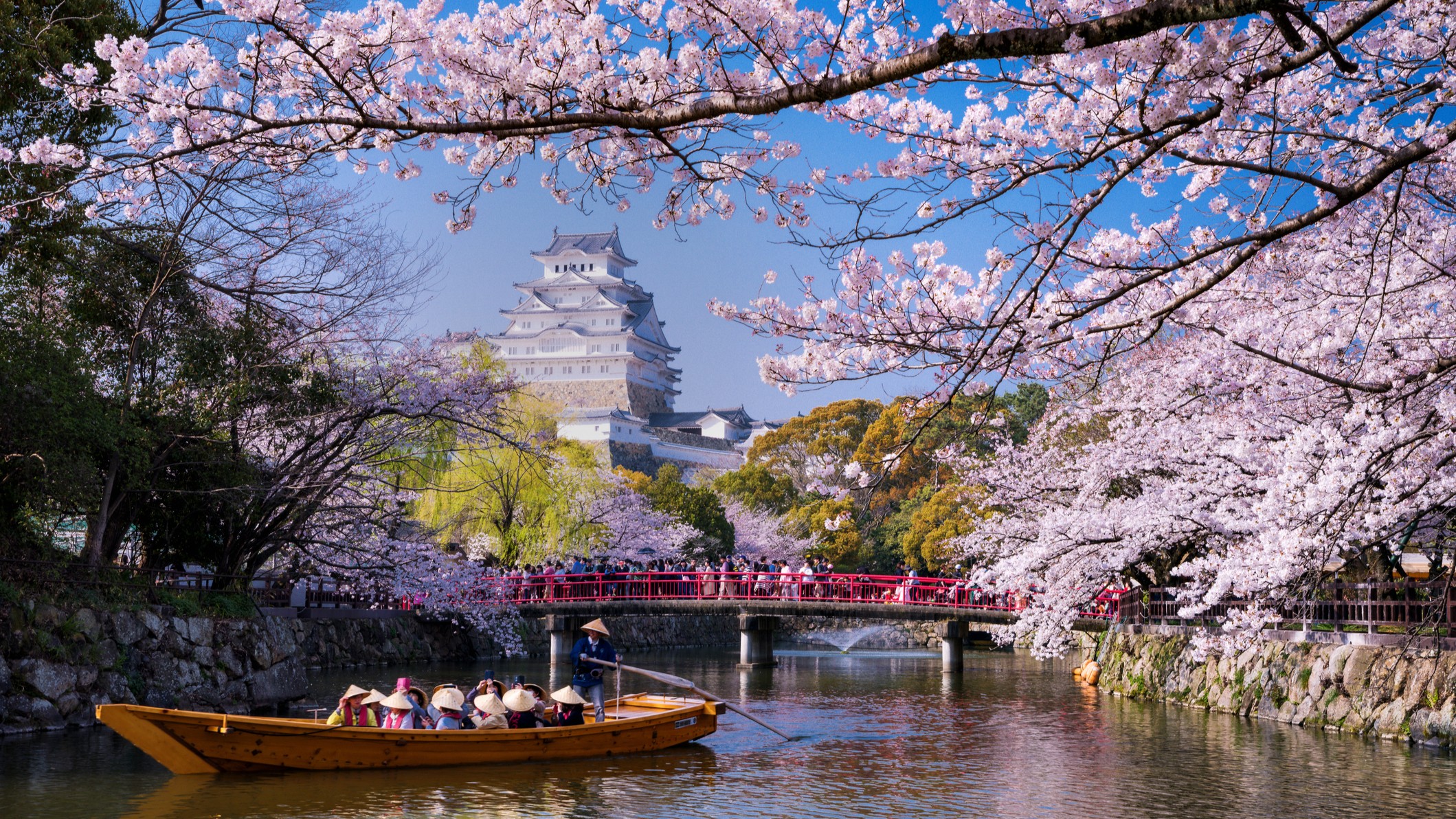 Hyogo, Japan a boat sails from the direction of Himeji Castle in spring