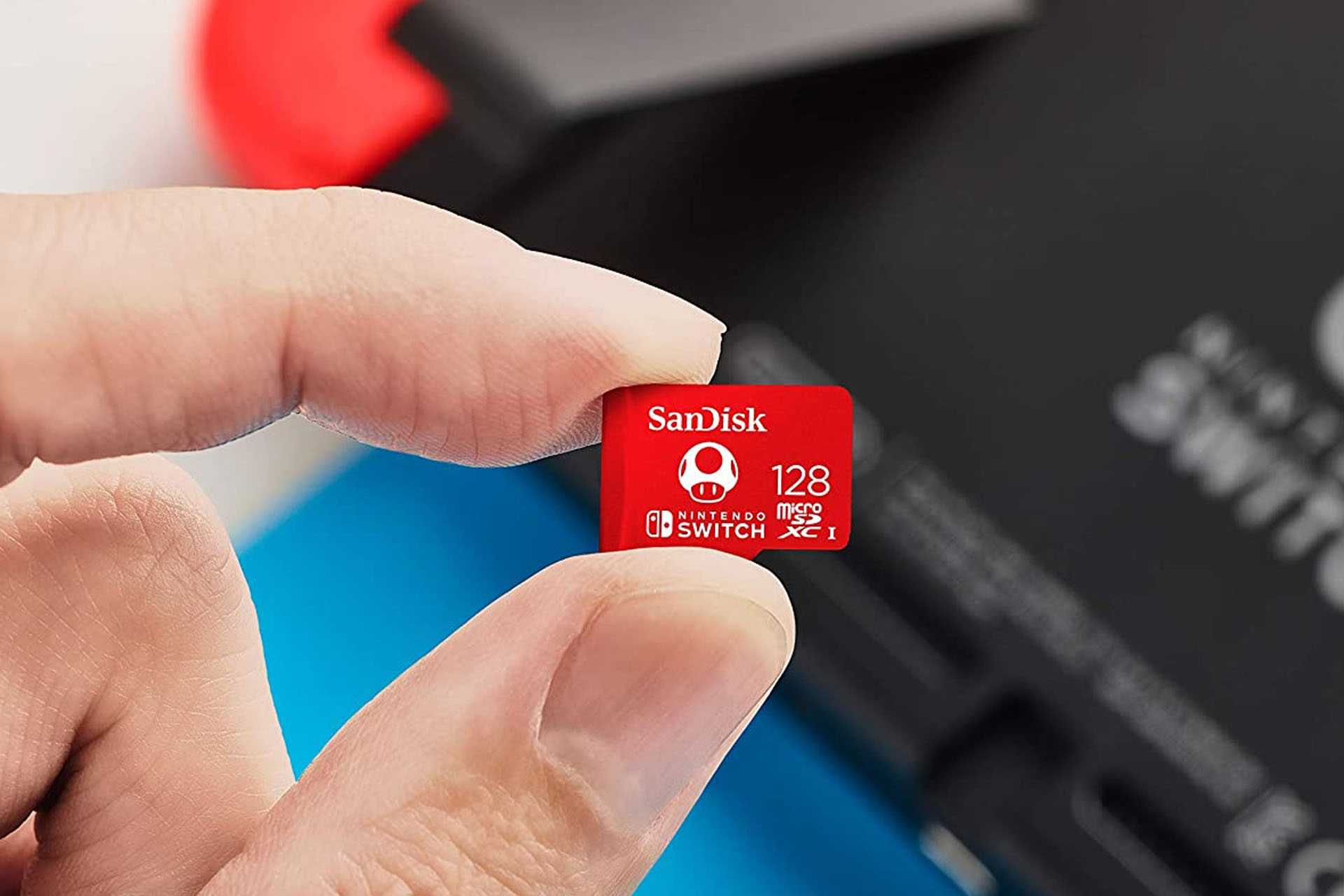 Kuva käyttäjästä, joka pitää Nintendo Micro SD -korttia Switch-konsolinsa edessä