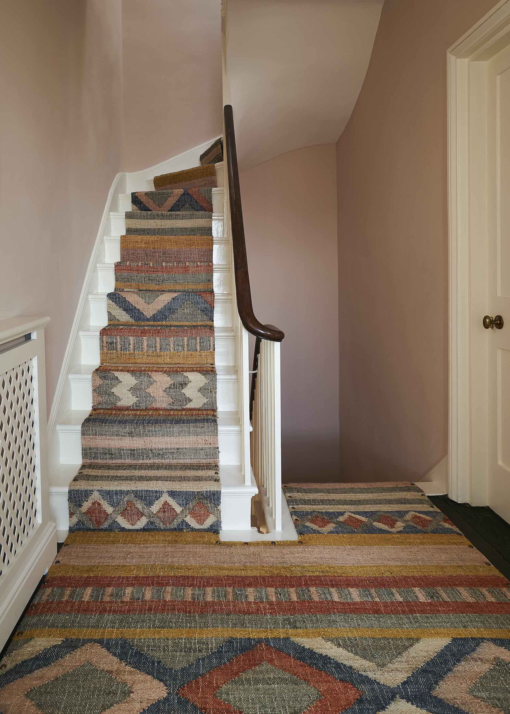 staircase with patterned runner and carpet