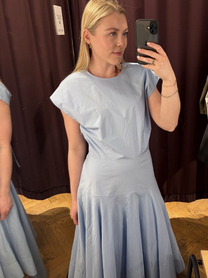 Woman wears blue dress