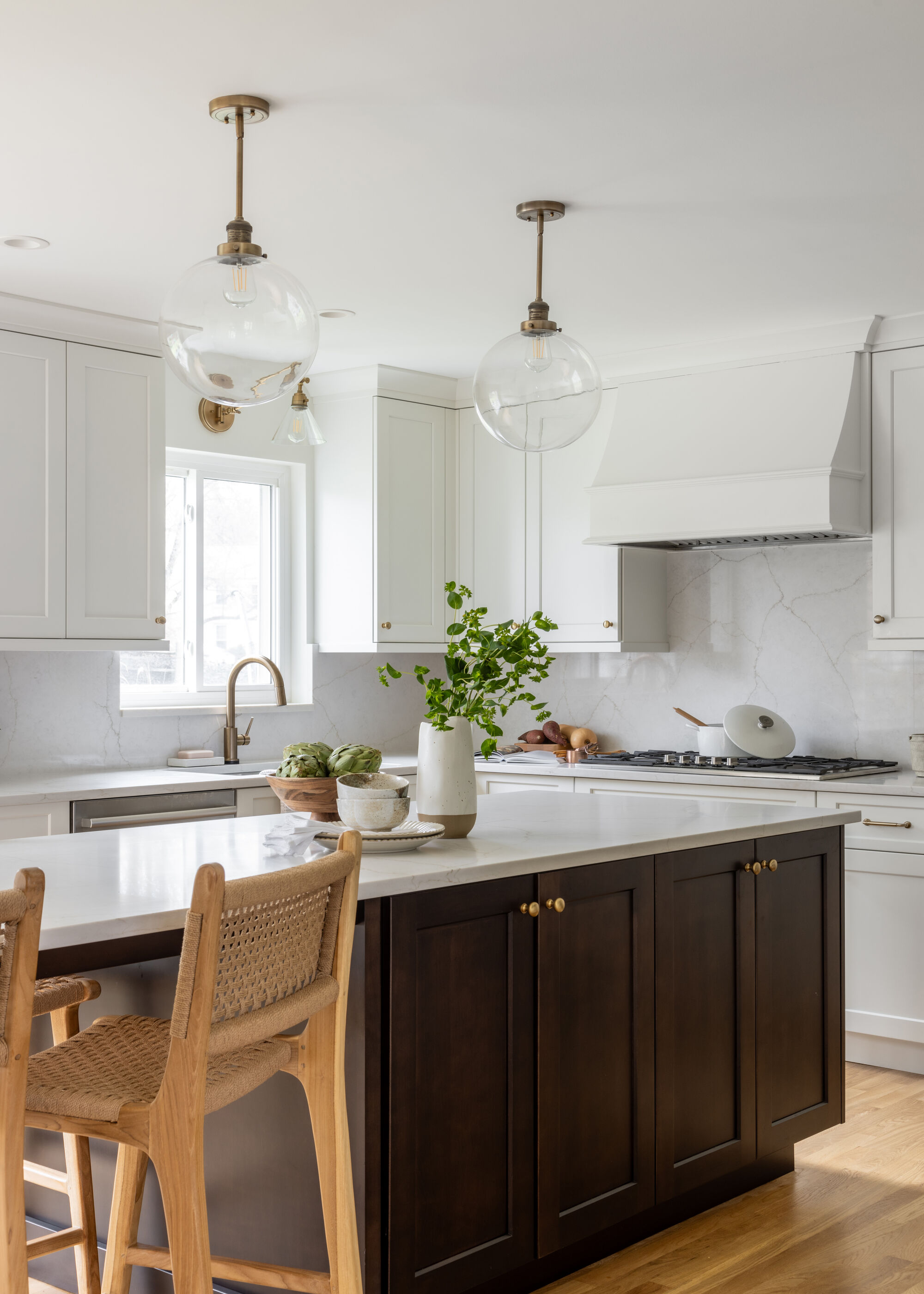 A small kitchen with white shaker cabinetry and an island