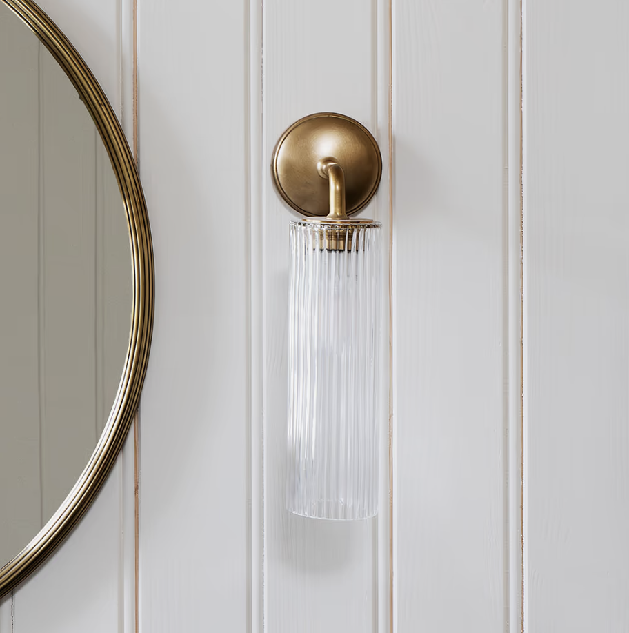 ribbed glass bathroom lights on a paneled wall