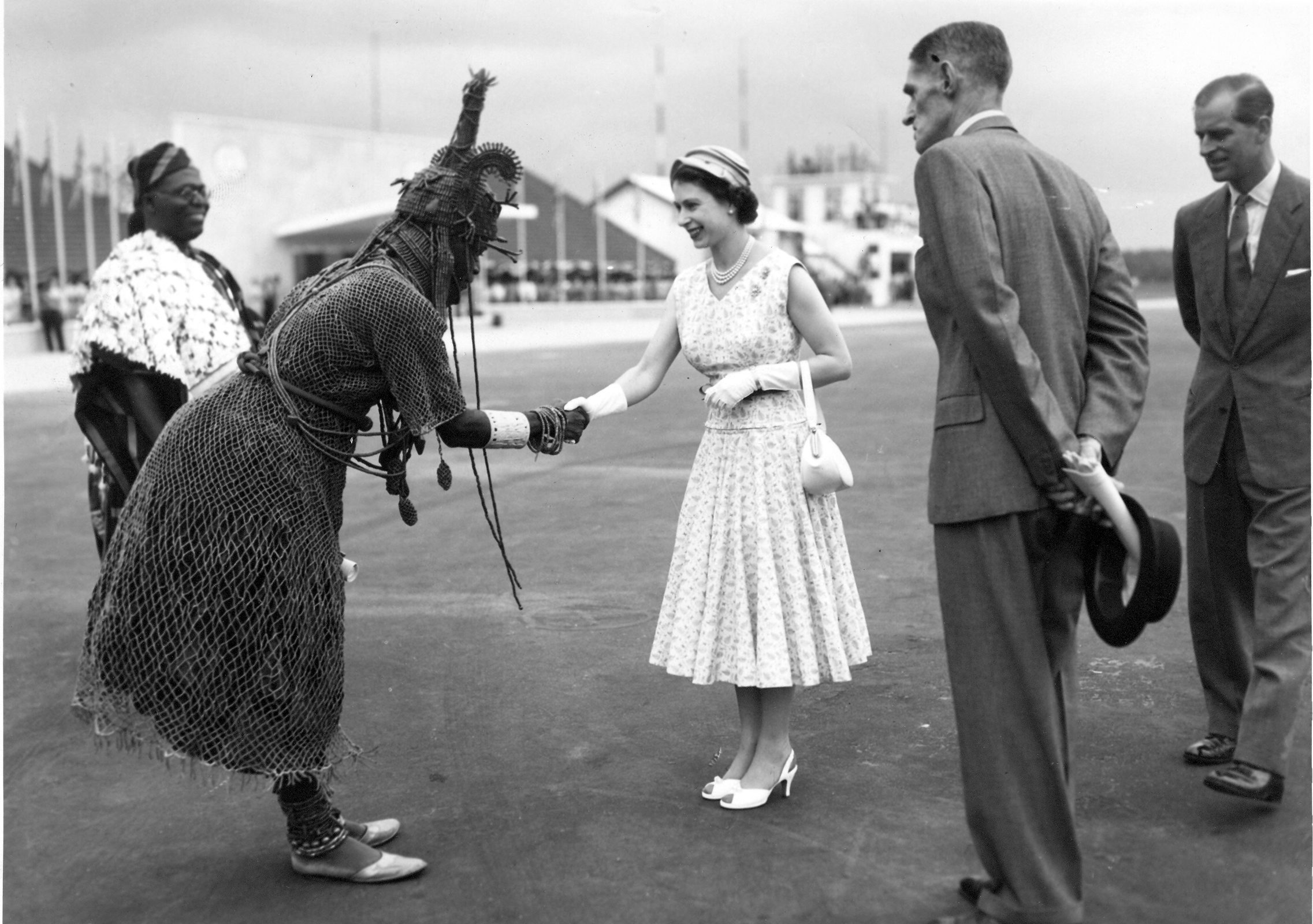 Queen Elizabeth shaking hands with a man in Nigeria