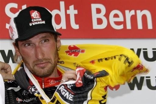 Vladimir Karpets dons the final yellow jersey of the Tour de Suisse.