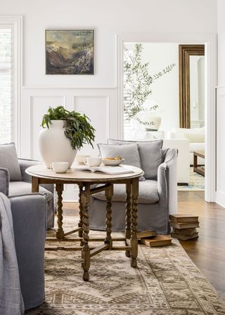 gray armchairs with wooden dropleaf table and vintage rug