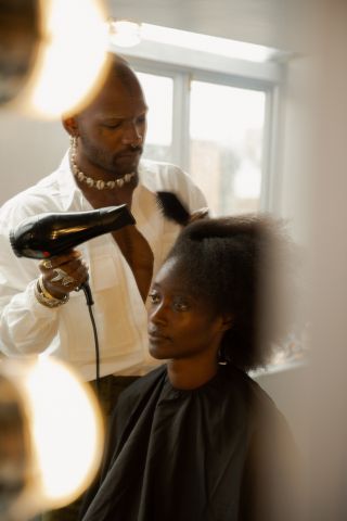 Hairstylist Issac Polen working on a clients hair during his Browns London residency
