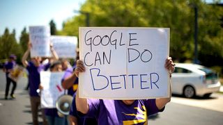 A protester on a march holding up an anti-Google placard