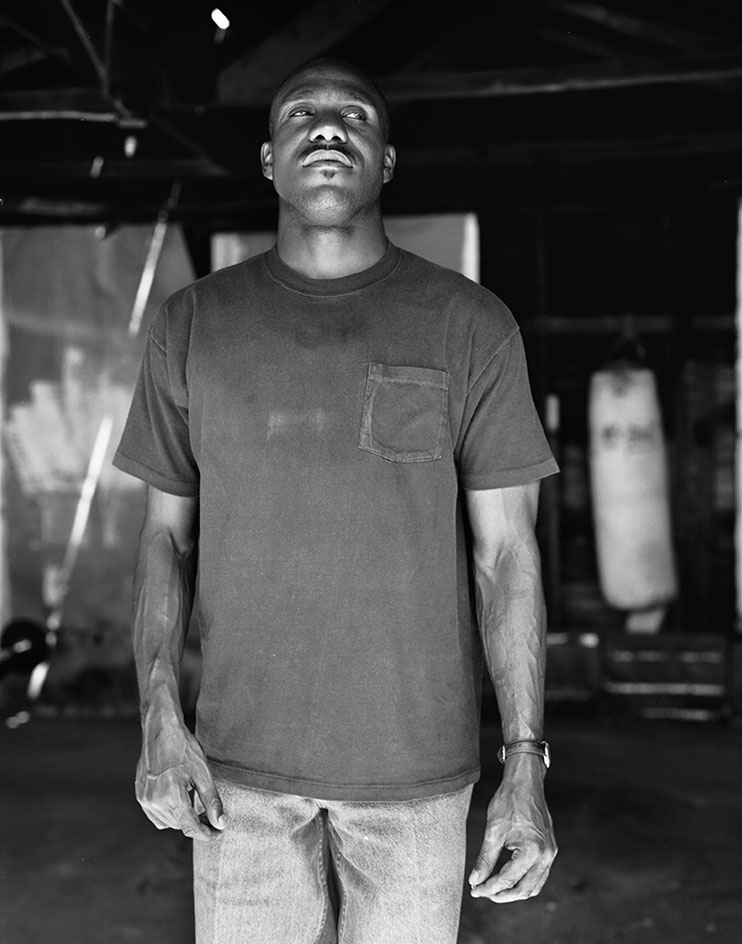 Black man standing and thinking something