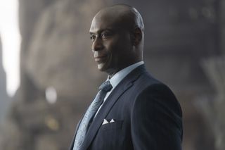 Lance Reddick as Zeus in Percy Jackson And The Olympians, wearing a suit and tie