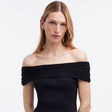 Woman wearing off-the-shoulder black Madewell top.