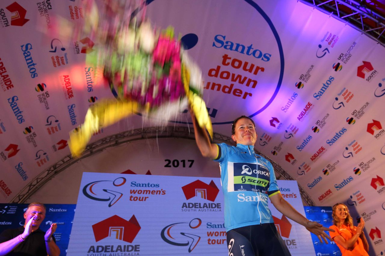 Amanda Spratt throws her podium flowers to the crowd