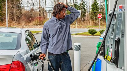 picture of shocked man pumping gas