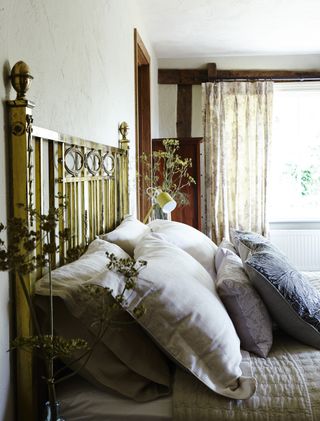 Bedroom in the Bunyans' Grade II listed 16th century former coaching inn from Period Living magazine