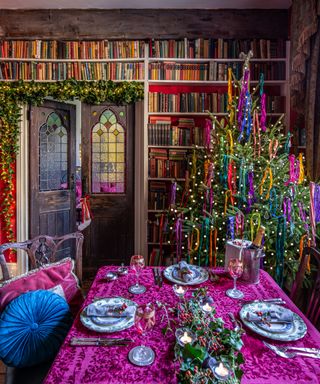 library and dining room in old house decorated for christmas in jewel colors