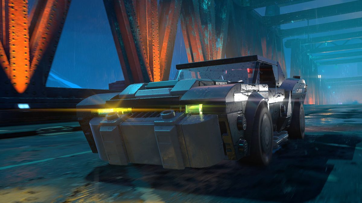 Batman rides the Batmobile across a bridge in Gotham City in Lego Batman: Legacy of the Dark Knight