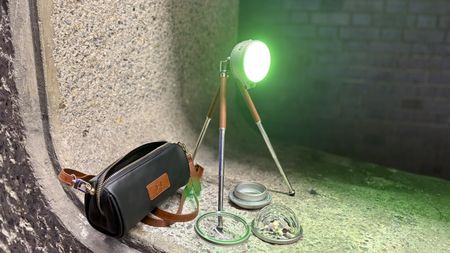 Close shot of the tripod-mounted Sol 5 Spectra plus accessories including the domed Magic Lens and the faux leather carry bag