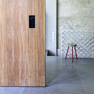 Room with wooden door and stool