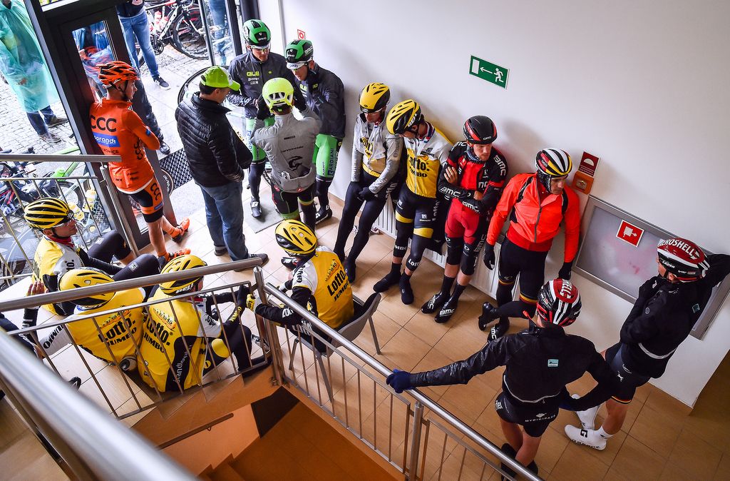 The riders enjoy the warm and dry as the race organisers make their decision to cancel the stage