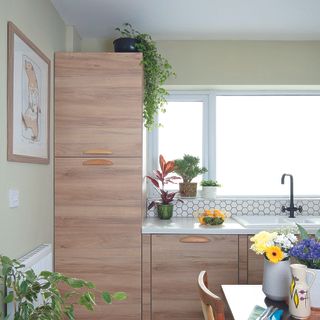 Wooden effect kitchen with sage green walls