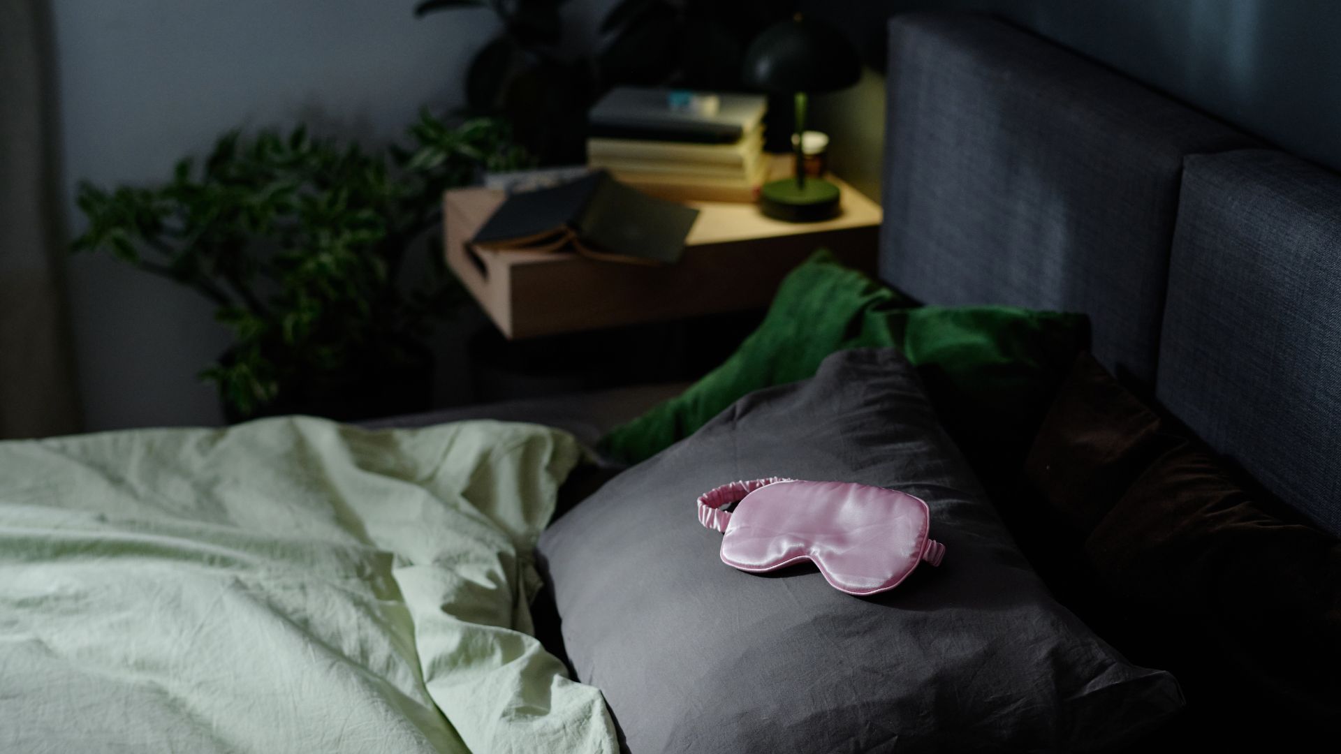 Silk eye mask on top of a bed