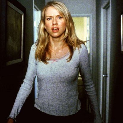 naomi watts walks down a hallway looking scared in a still from the ring