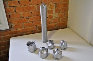 Brick wall left, white wall right, mock torch in silver with silver components