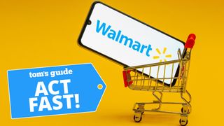 Smartphone with Walmart logo nestled into a mini shopping cart