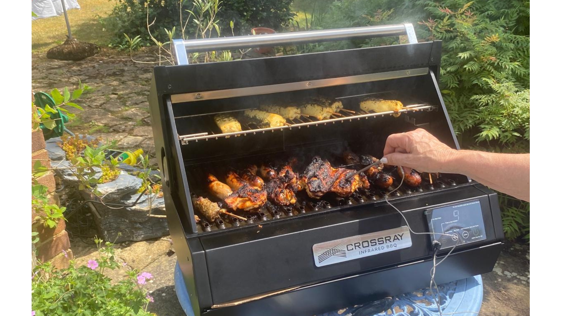 The Dimplex Crossray eXtreme Portable Electric BBQ being used to cook meat by our tester, Lesley