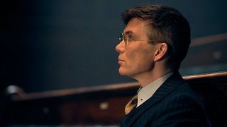 Tommy Shelby with glasses looking afar from side angle