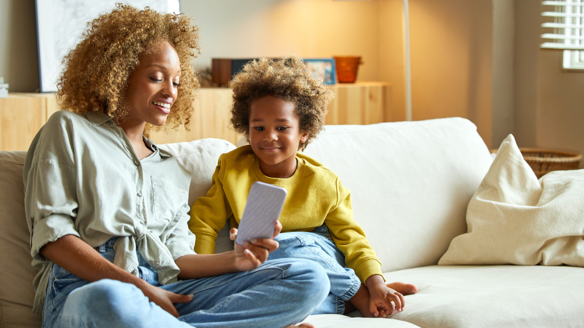 Mother using a phone with her child