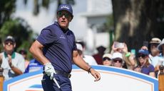 Phil Mickelson looks on after hitting a drive