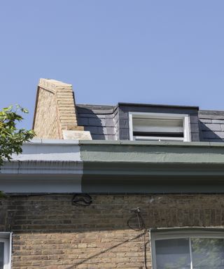 Roof and chimney of house with mansard loft conversion
