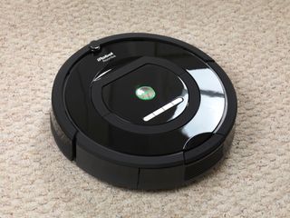 A black Roomba robot vacuum cleaner