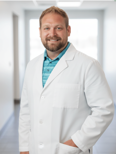 Man in lab coat poses for profile picture