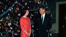 President John F. Kennedy with wife posed before the White House Christmas tree