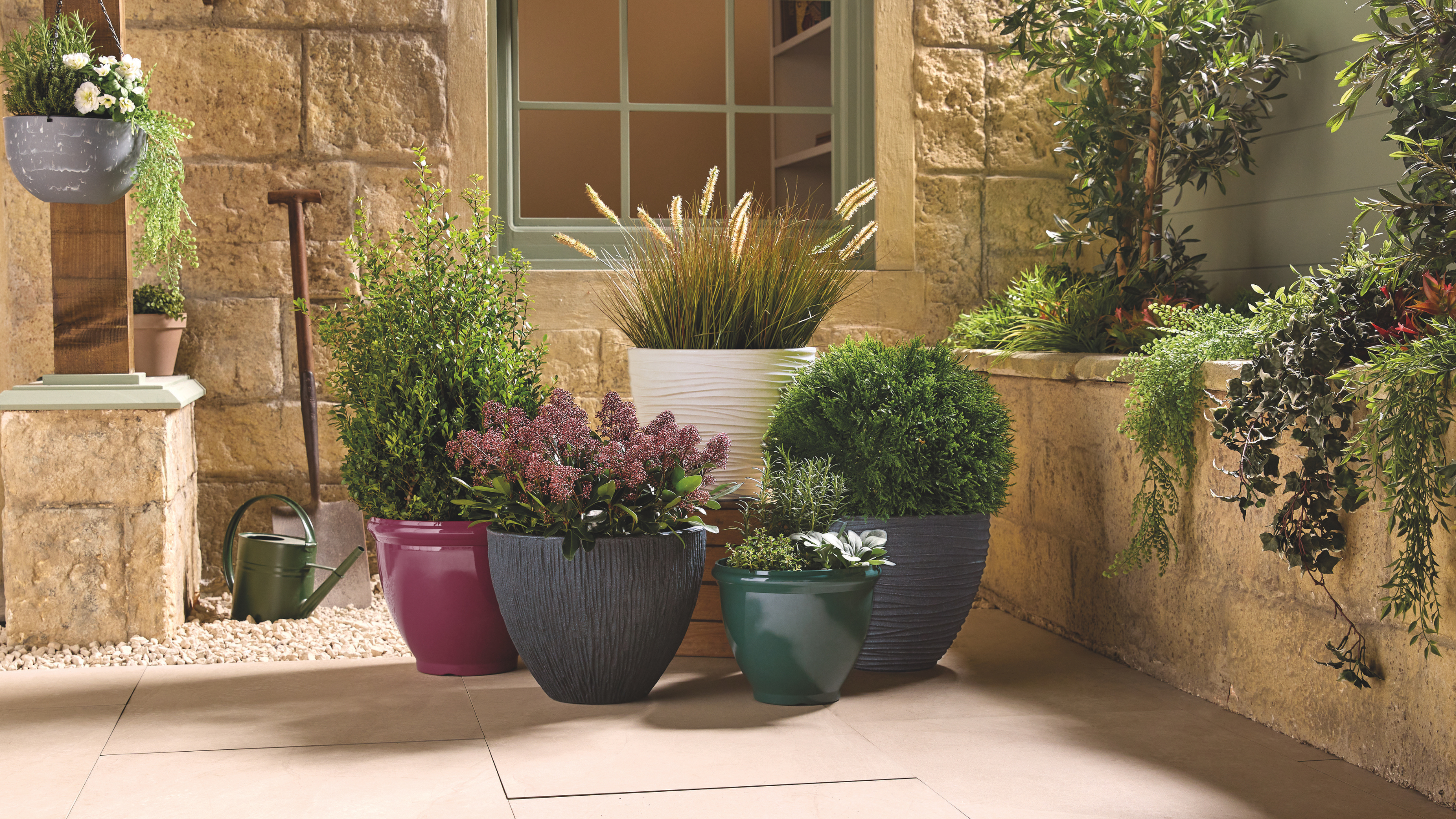 5 Aldi planters on a patio.