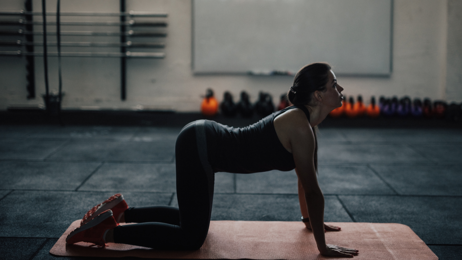 A woman doing the cat cow stretch