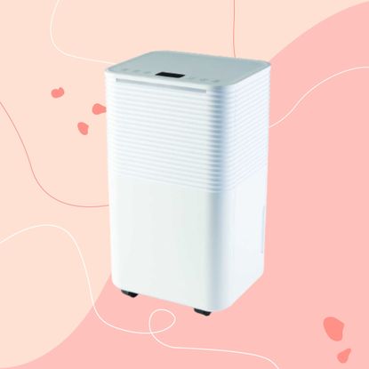 White Aldi dehumidifier against pink background