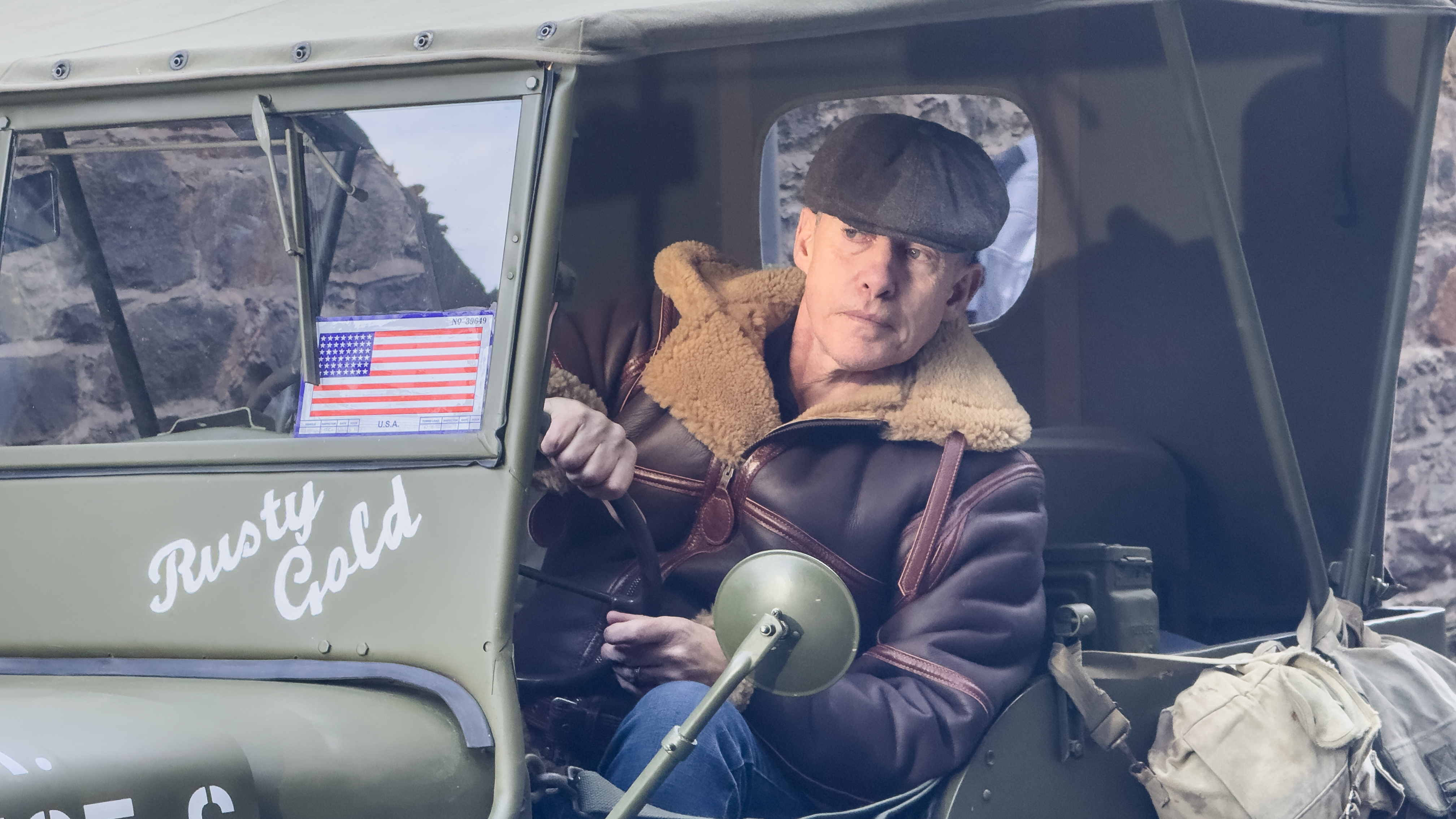 A man leaning out of an old army jeep lit by the Harlowe Blade 5 & 10 LED Lighting Kit