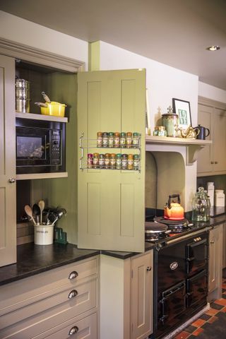 metal spice rack attached to inside of kitchen cabinet door