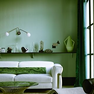 white sofa against green wall