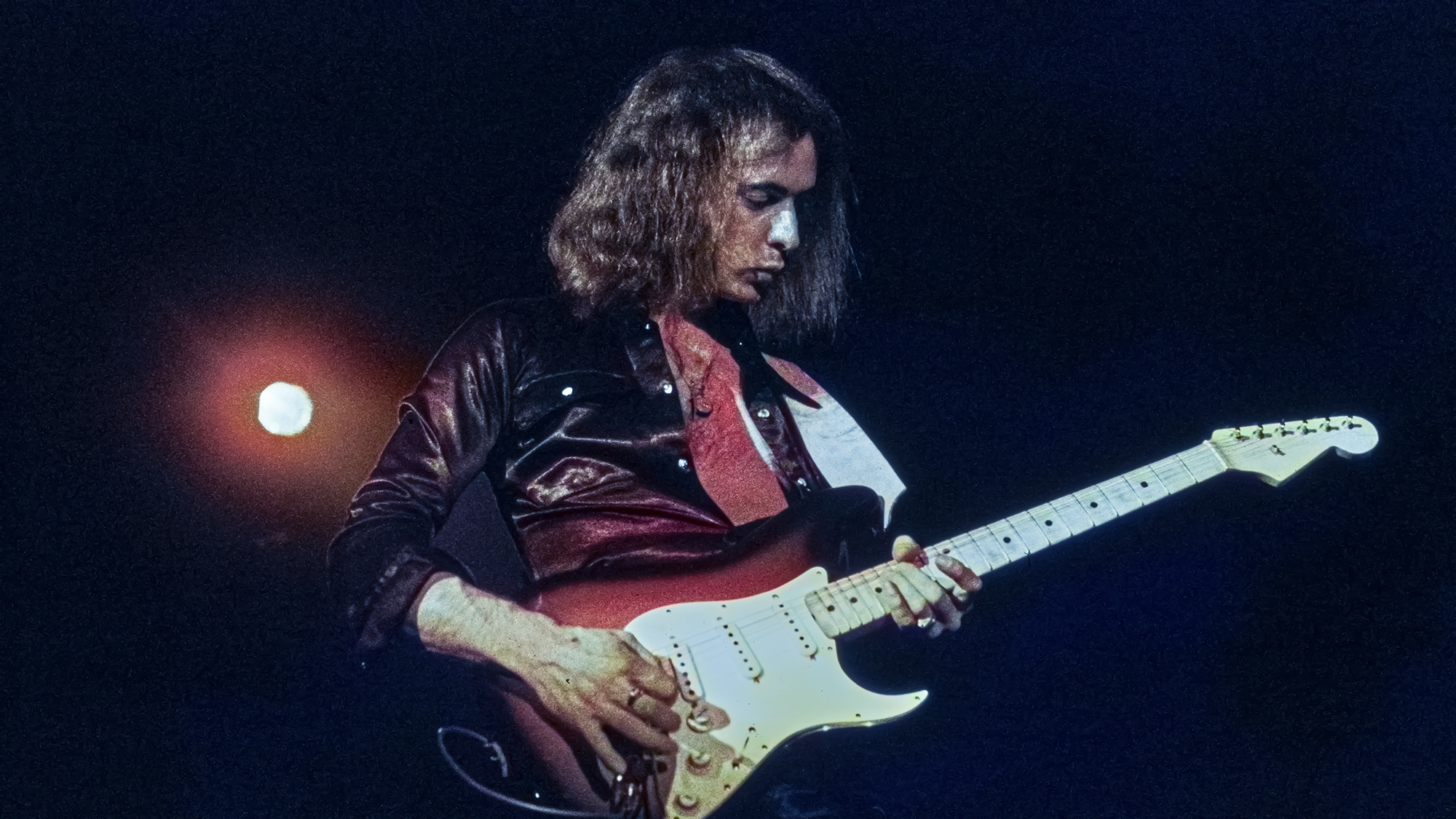 British guitarist and songwriter Ritchie Blackmore, wearing a black shirt, playing a Fender Stratocaster in sunburst, as his band, British rock band Deep Purple, performs live, 1972.